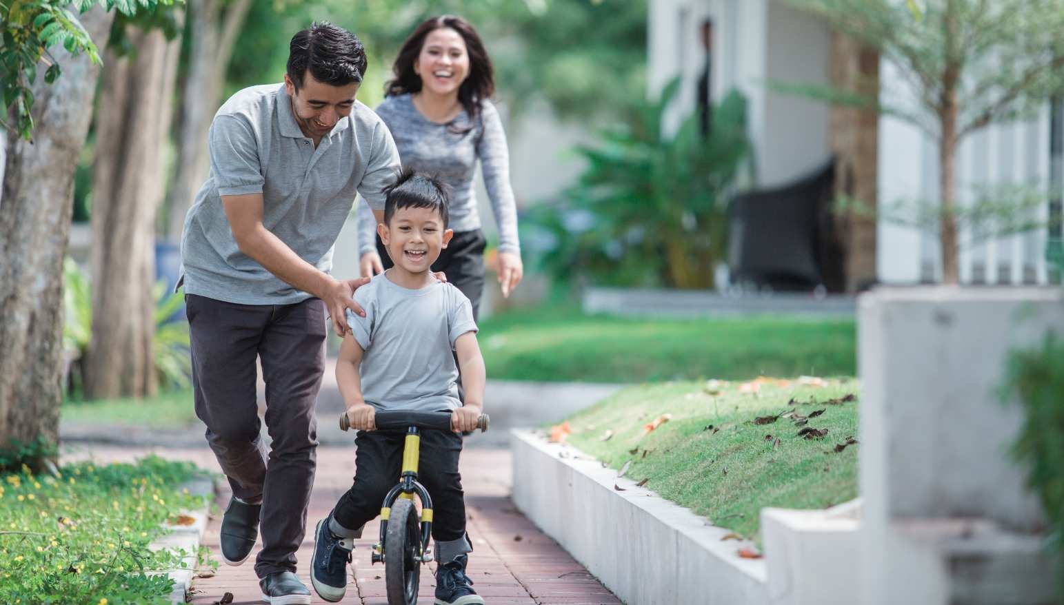 Young couple and kid riding a bike